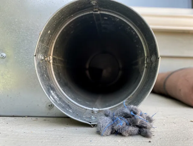 Wallingford Dryer Vent Cleaning technician using specialized equipment to clear severe dryer vent blockage in Wallingford